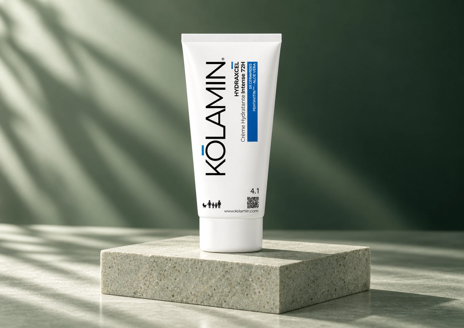 Kolamin Hydraxcel skincare: a white tube with blue accents on a stone plinth, in soft light and green tones